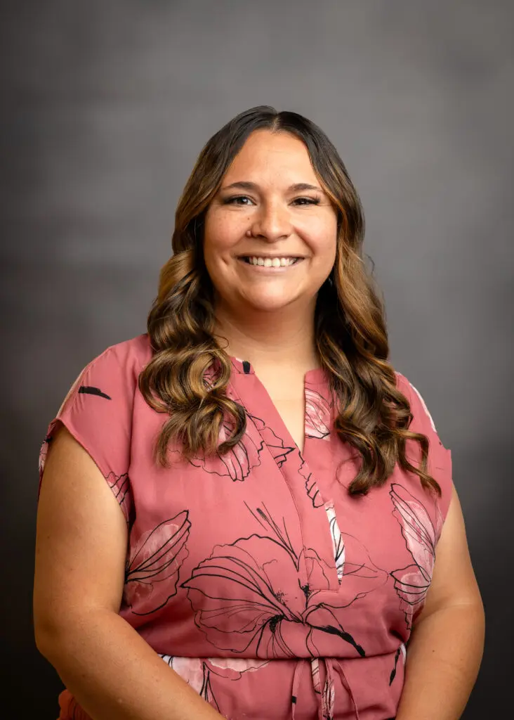 Woman with long hair, smiling warmly