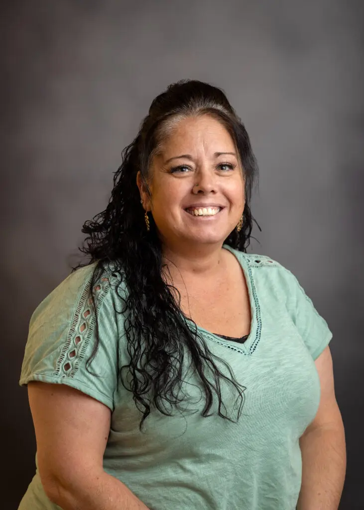 Portrait of woman against grey background