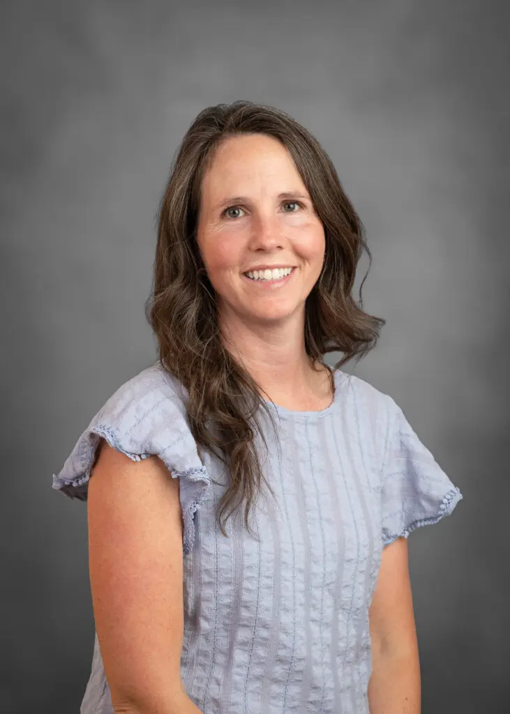 Portrait of a woman against gray background