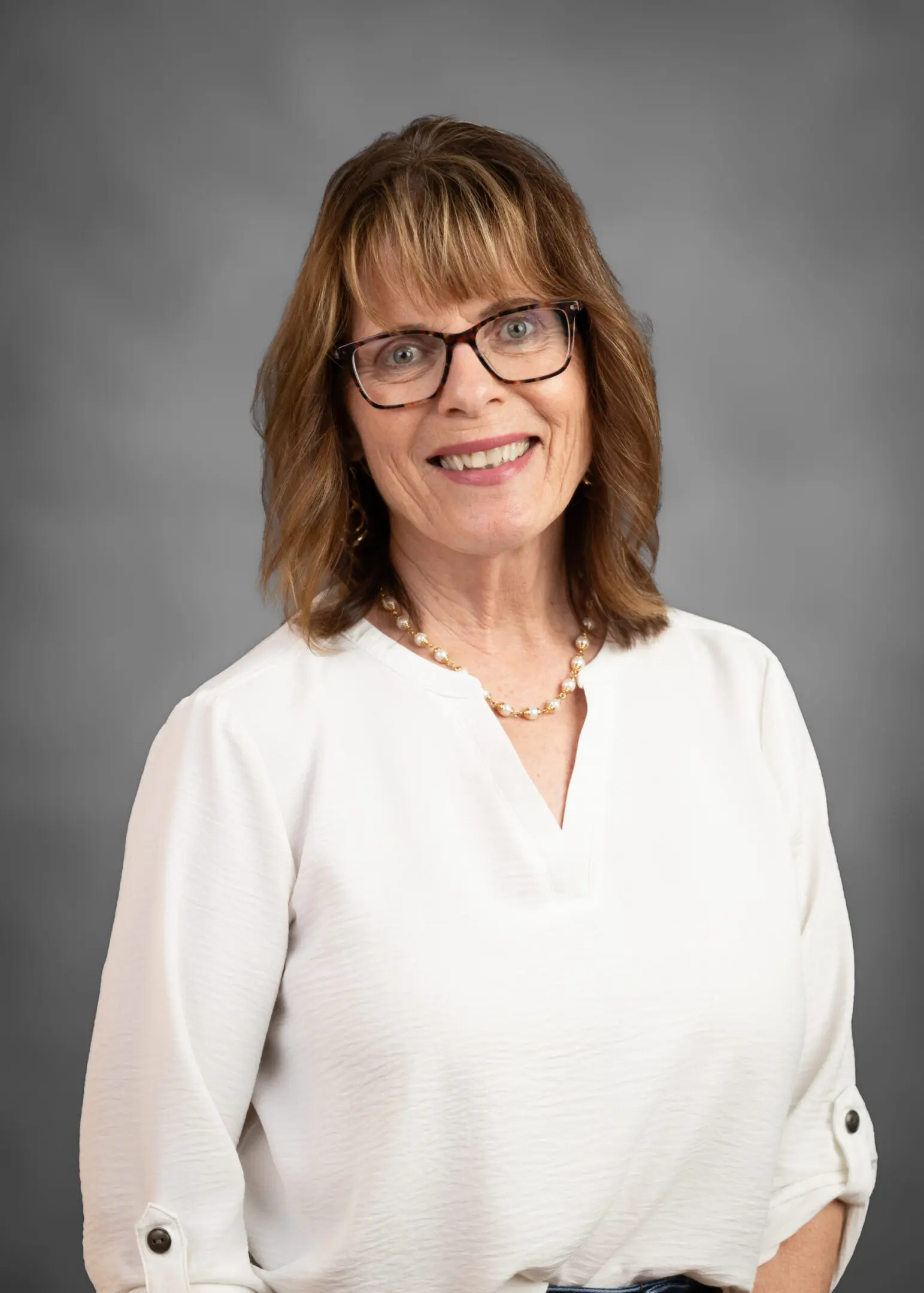 Friendly woman wearing a white shirt.