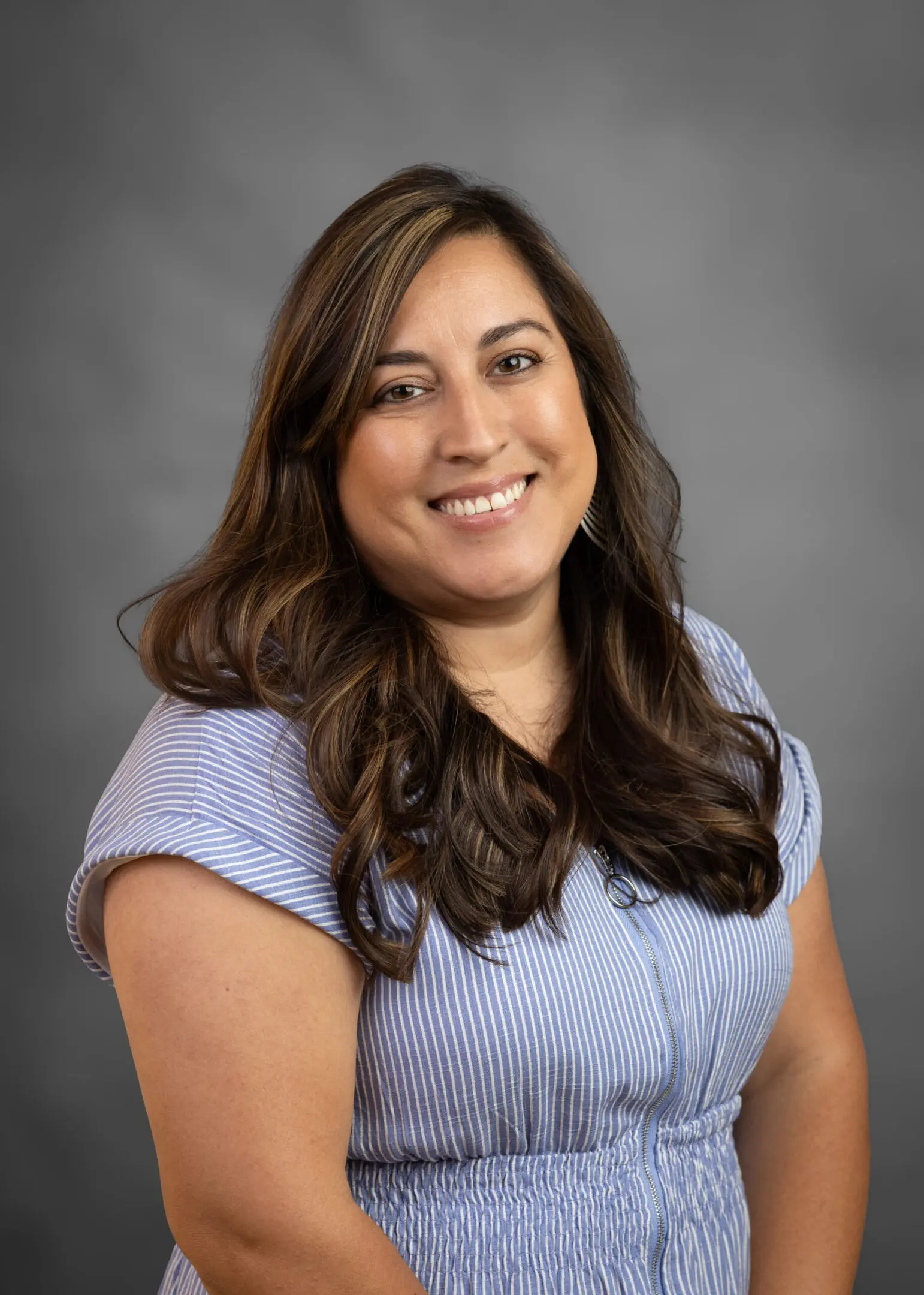 Smiling woman in striped blue dress