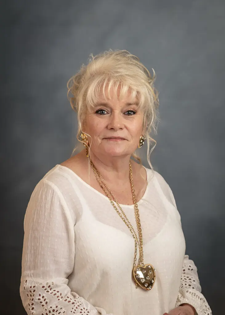 Senior woman posing against gray background
