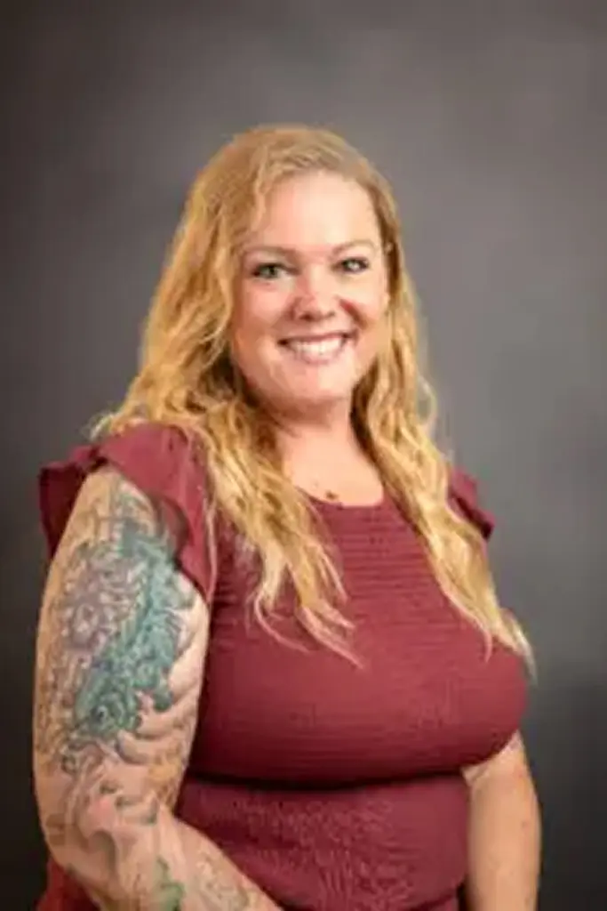 Woman with tattoo and maroon top
