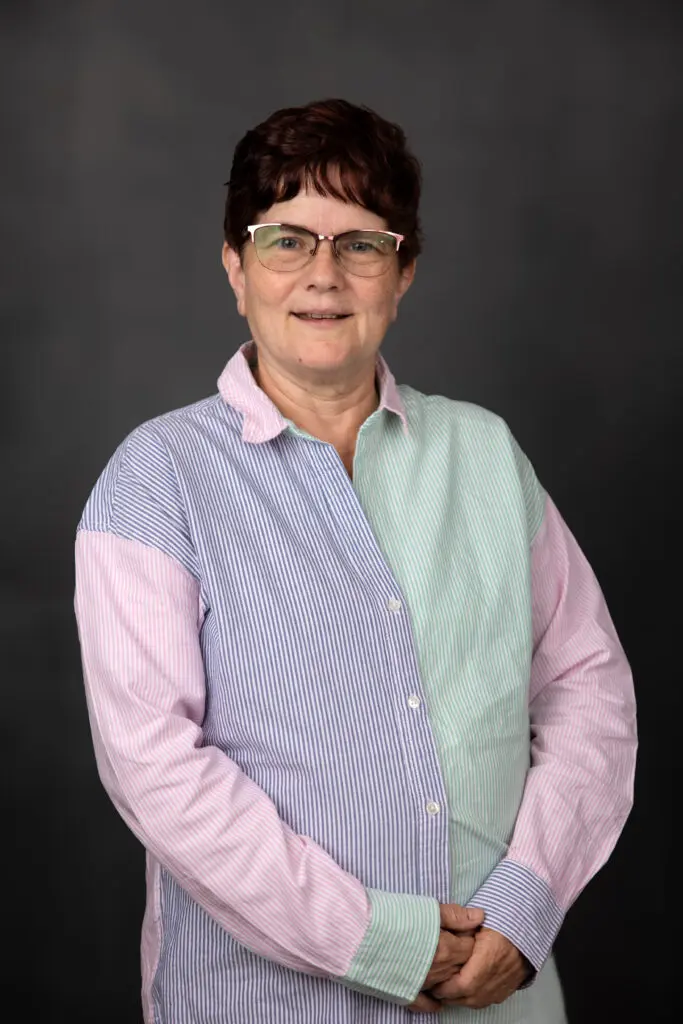 Portrait of a woman against dark background