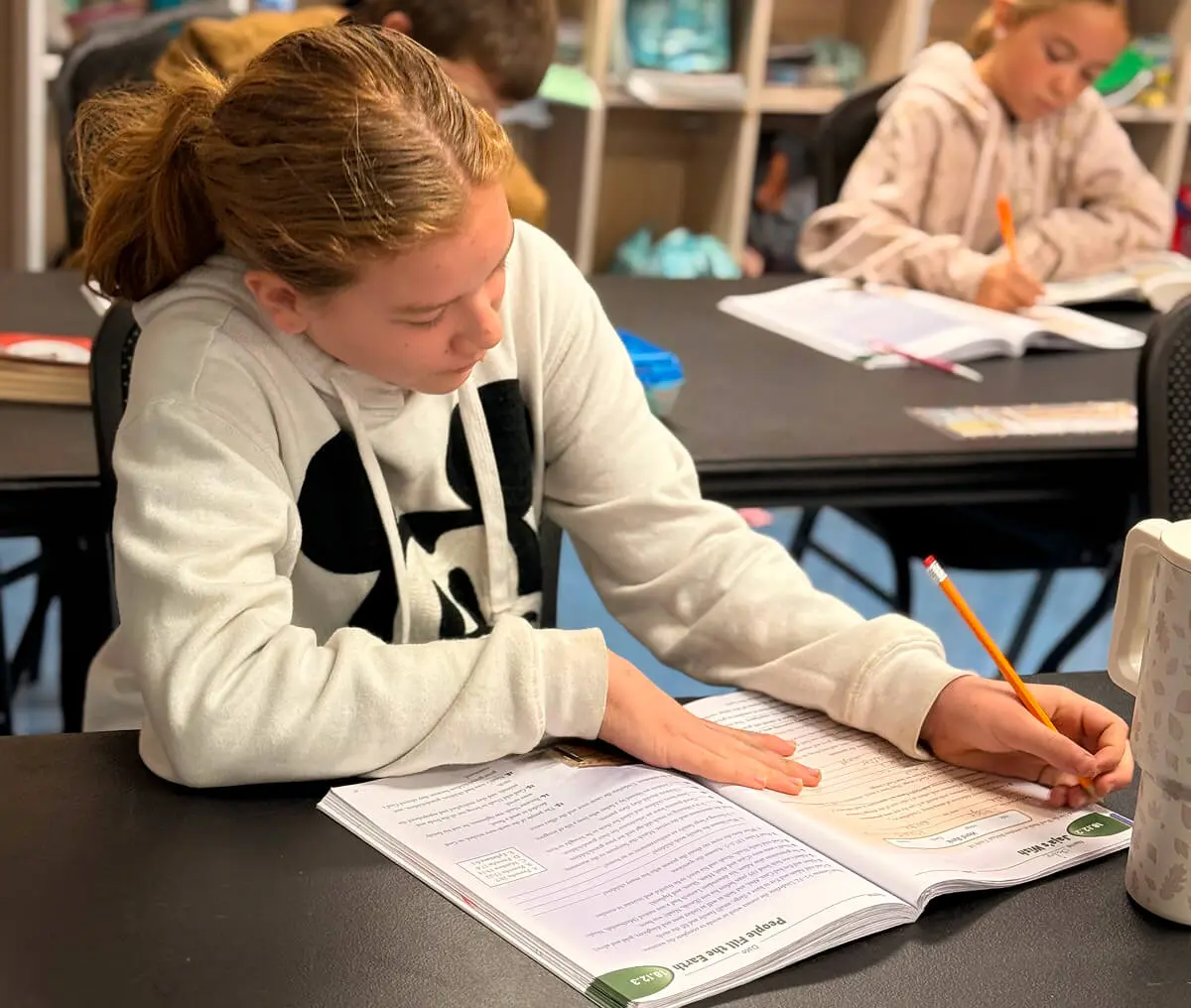 Girl doing homework at school desk