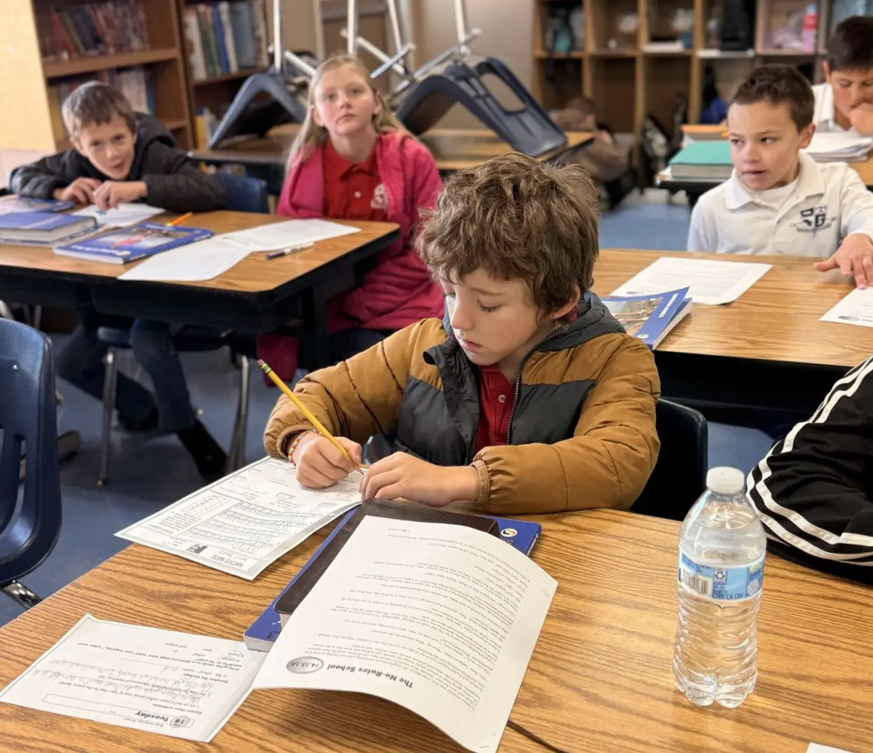Child writing at school desk