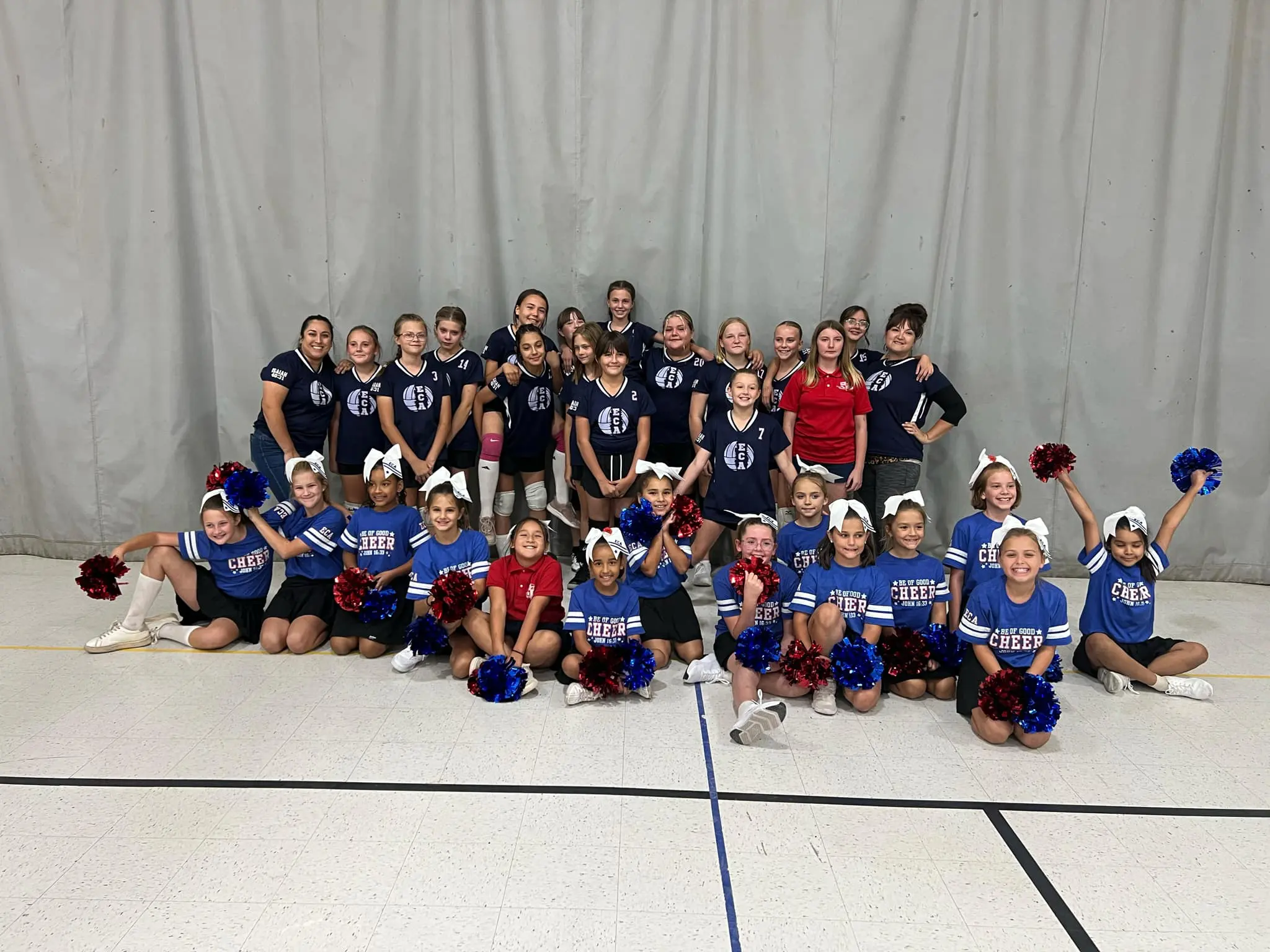 Cheerleading team posing with pom-poms